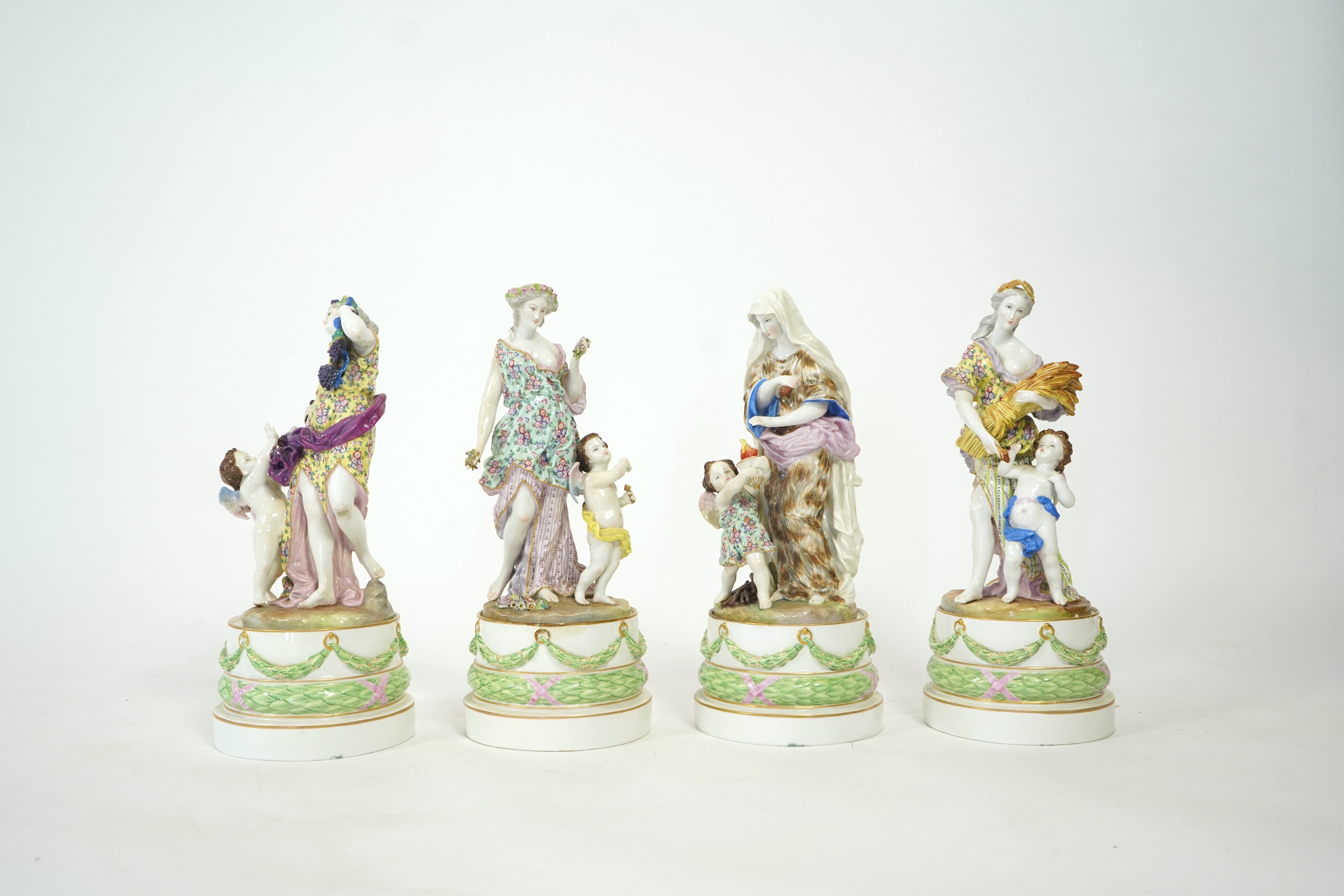 A set of four large Meissen style 'Four Seasons' groups and separate pedestals
